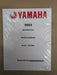 A Yamaha 2023 motorcycle service manual, sealed in clear plastic wrap, placed on a brown cardboard background.