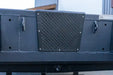 Close-up of a dark gray metal transom board with a textured diamond-patterned black cover mounted in the center.